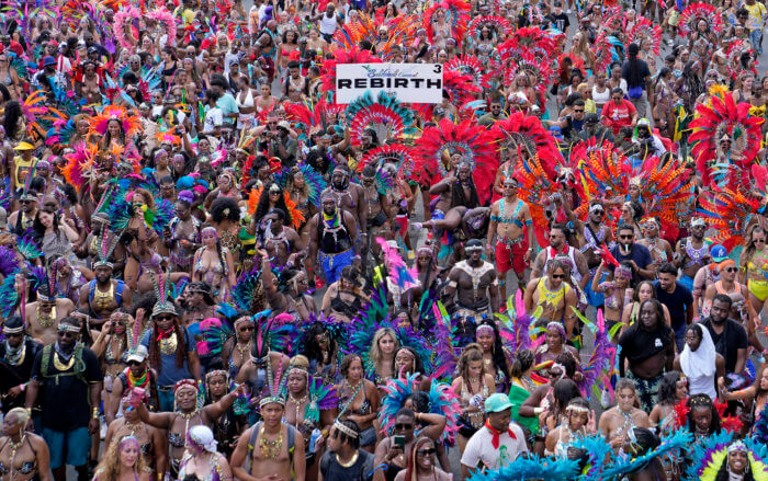 Masqueraders attend the Caribbean Carnival parade in Toronto, Canada, Saturday, July 30, 2022. 