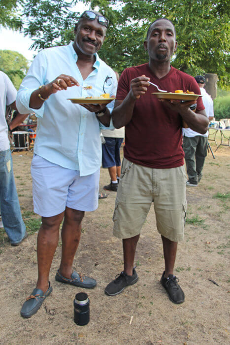 Terrance "Terry" Edwards, left, feasting on local delicacies, with Glenroy "Goebel" Phillips.