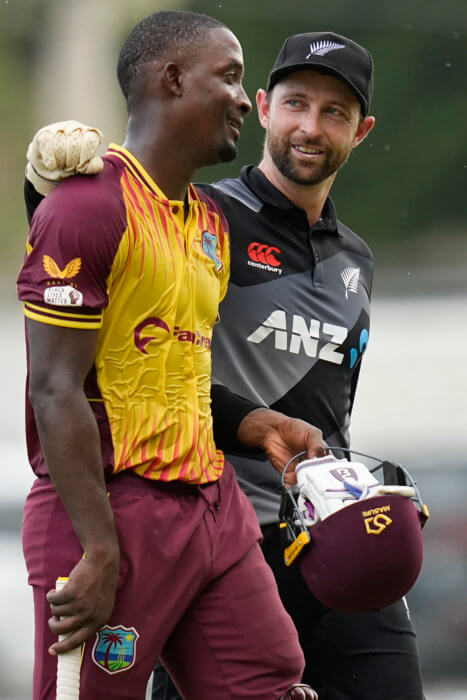 West Indies' Shamarh Brooks leaves the field not out embraced by New Zealand's Devon ConwayÊafter their third and last T20 cricket match at Sabina Park in Kingston, Jamaica, Sunday, Aug. 14, 2022. West Indies won by 8 wickets.