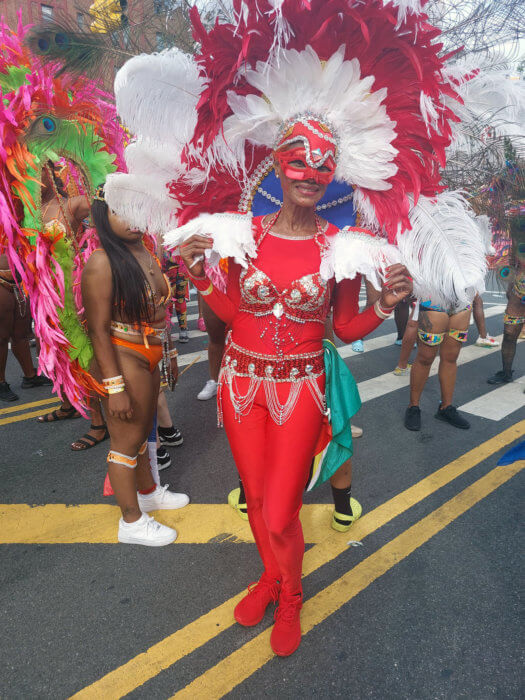 A masquerader decked out in a costume designed with a towering headpiece by master wire-bender and costume designer, Clifford Smith Jr. of Trinidad & Tobago. 