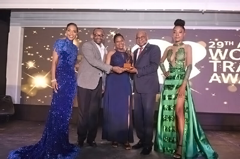 Hon. Edmund Bartlett, Minister of Tourism (2nd from R), accepted JamaicaÕs destination awards at the World Travel Awards Caribbean & The Americas 2022 Gala Ceremony. Sharing in the moment are (L-R): M.C. for the event, Dr. Terri Karelle Reid; Donovan White, Director of Tourism; Jennifer Griffith, Permanent Secretary at the Ministry of Tourism; and a World Travel Awards model (R).