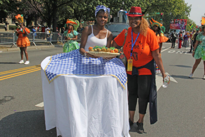 Rose Guerrier, right, co-band leader of the Haitian group, Creole Jam, with masquerader depicting the famous Haitian soup, Soup Joumou.