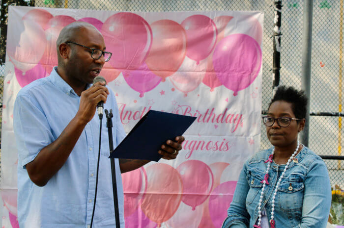 Queens Borough President Donovan Richards Jr. left, presents Allison Alexis (founder) with a Citation of Honor at the 7th Annual Queens Cancer Walk in Smokey Park.