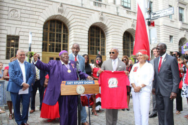 From left, Commissioner Manuel Castro, MayorÕs Office of Immigrant Affairs, legendary calypsonian Lord Nelson, CG J. Andre Laveau, Mayor Eric L. Adams, Hazra Ali, partly hidden, Edward Mermelstein, MayorÕs Office of International Affairs, and Ambassador to the US, Anthony Phillips Spencer, at the T&T Golden Jubilee flag raising at Bowling Green in NYC.