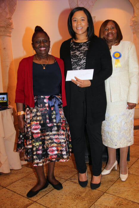 Dr, Claudette Gordon, left, presents award to Mariel Walcott, flanked by Dr. Virginia Bernard.
