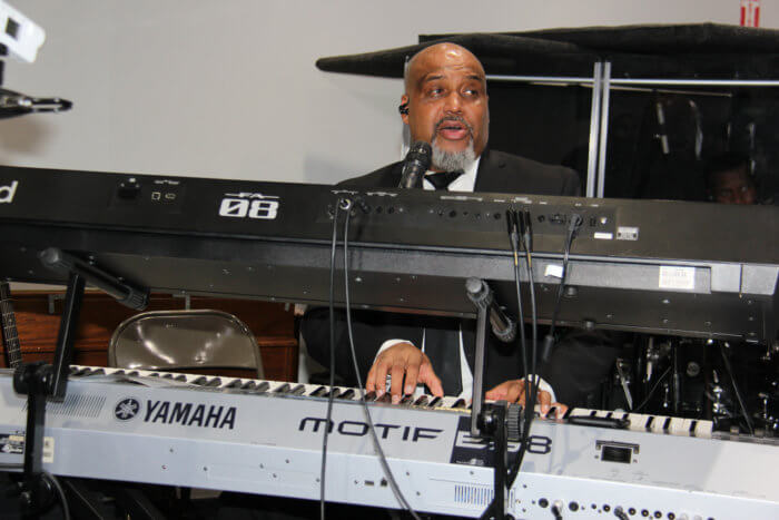 Shaun Cummings plays keyboard during congregational hymn "It is Well with My Soul." 
