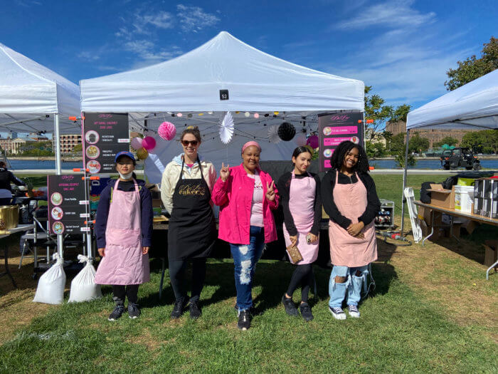 De'Lor Cakery Founder and CEO Kayisha Thompson with a few of her employees at an event. 