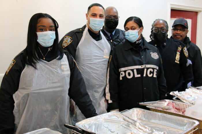 Officers from the Community Affairs Department of the NYPD’s 88th Precinct in the Bedford-Stuyvesant section of Brooklyn get ready to serve Thanksgiving meal.