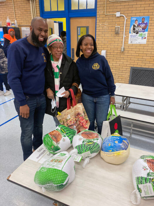 Brian Cunningham and Rita Joseph pose with a constituent who showed up to get her Thanksgiving turkey.