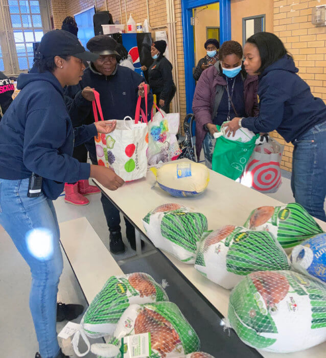 Florentine Ulysse, principal of the Toussaint L’Overture Elementary School in Brooklyn (left) and Rita Joseph (right) assisting constituents during the turkey giveaway.