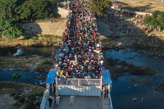 Haitians wait to cross the border between Dominican Republic and Haiti in Dajabon, Dominican Republic, Friday, Nov. 19, 2021.