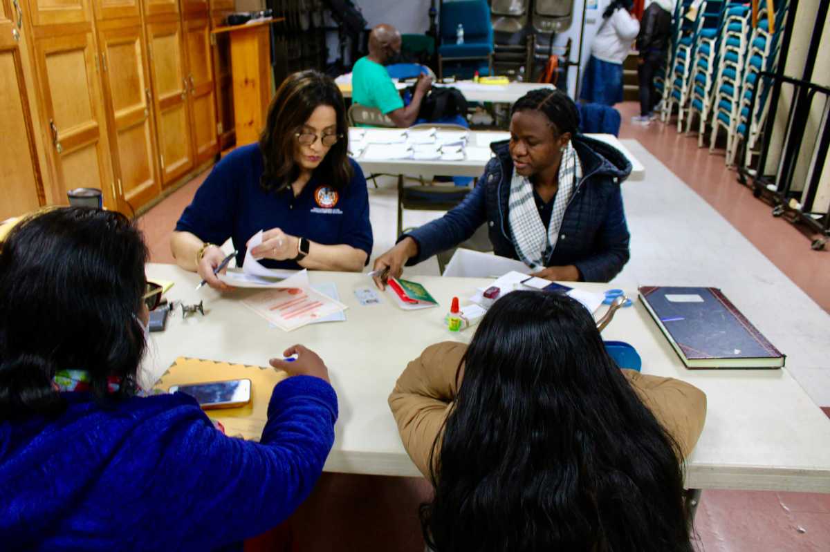 Guyanese nationals being attended to by staff, Fazia Khusia, and Niacifa Watson, during the first Brooklyn Outreach, at Restoration Temple Assembly of God in Brooklyn, on Nov. 19.