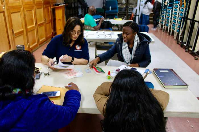 Guyanese nationals being attended to by staff, Fazia Khusia, and Niacifa Watson, during the first Brooklyn Outreach, at Restoration Temple Assembly of God in Brooklyn, on Nov. 19.