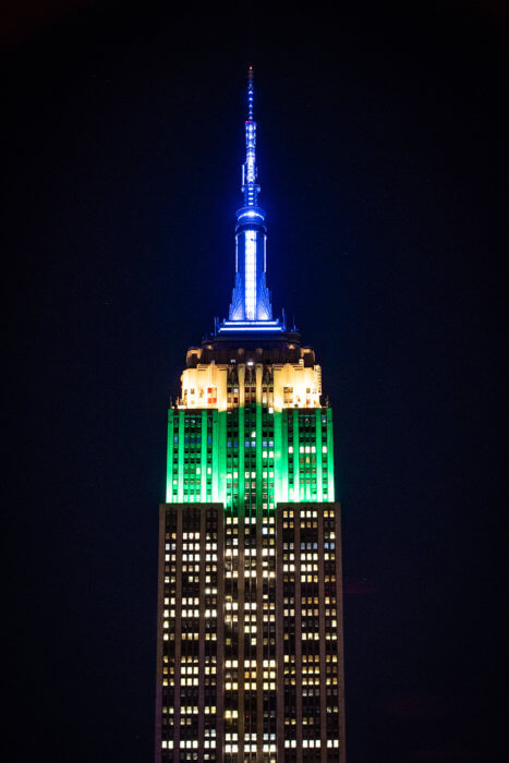 The Empire State Building lit in the colors of the St. Vincent and the Grenadines flag.