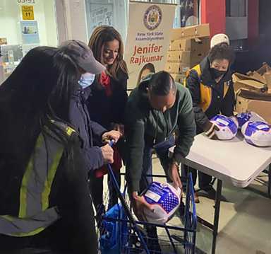 Assemblywoman Rajkumar and Zara Charitable Foundation Representatives hand out over 400 Thanksgiving turkeys.