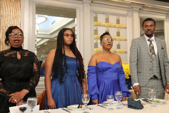 SVG Consul General Rondy McIntosh, with his wife (second from right) and daughter, and COSAGO President Laverne McDowald-Thompson, far left, during the singing of the National Anthems of the United States and St. Vincent and the Grenadines.