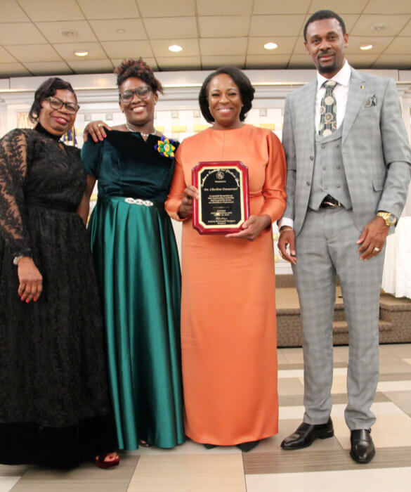 Dr. Charlene Emmanuel receives plaque from CONSAGO executive members, with Consul General Rondy McIntosh.