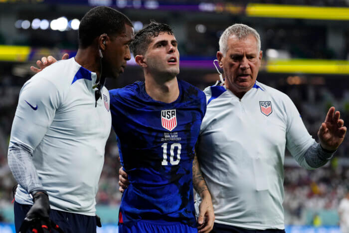 Christian Pulisic of the United States is helped off the pitch after suffering an injury during the World Cup group B soccer match between Iran and the United States at the Al Thumama Stadium in Doha, Qatar, Tuesday, Nov. 29, 2022.