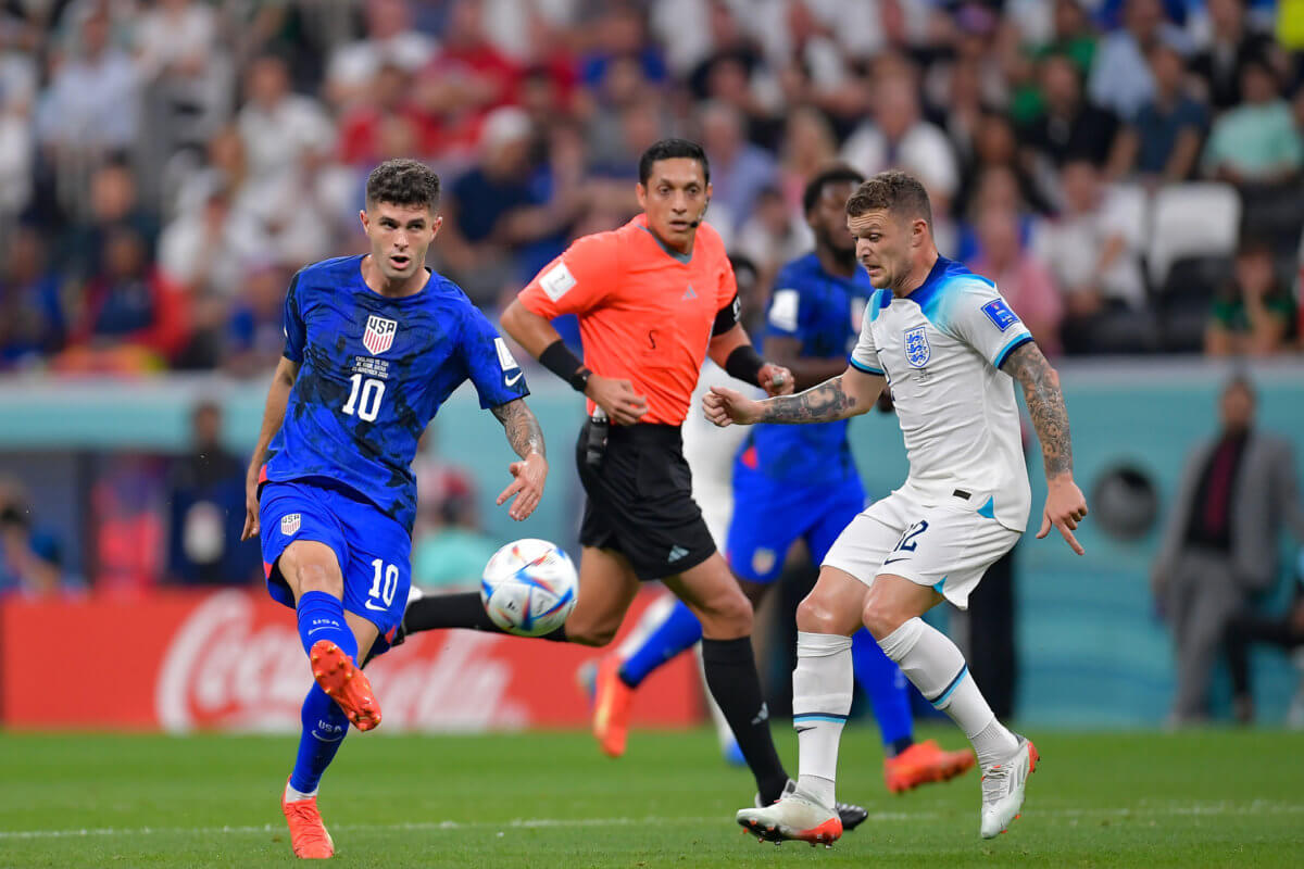 Christian Pulisic, left, of USA shoot in front of Jude Bellingham of England during the FIFA World Cup Qatar 2022 Group B match at Al Bayt Stadium on Nov. 25, 2022 in Al Khor, Qatar.