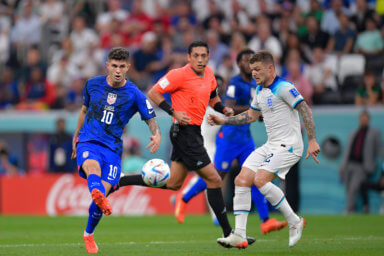 Christian Pulisic, left, of USA shoot in front of Jude Bellingham of England during the FIFA World Cup Qatar 2022 Group B match at Al Bayt Stadium on Nov. 25, 2022 in Al Khor, Qatar.