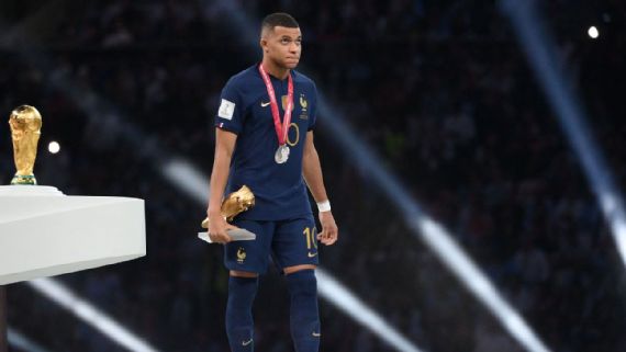 France’s Kylian Mbappe walks past the World Cup trophy after being awarded the Golden Boot in Qatar.