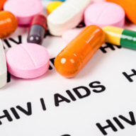 Pills on Hiv / aids paper background.