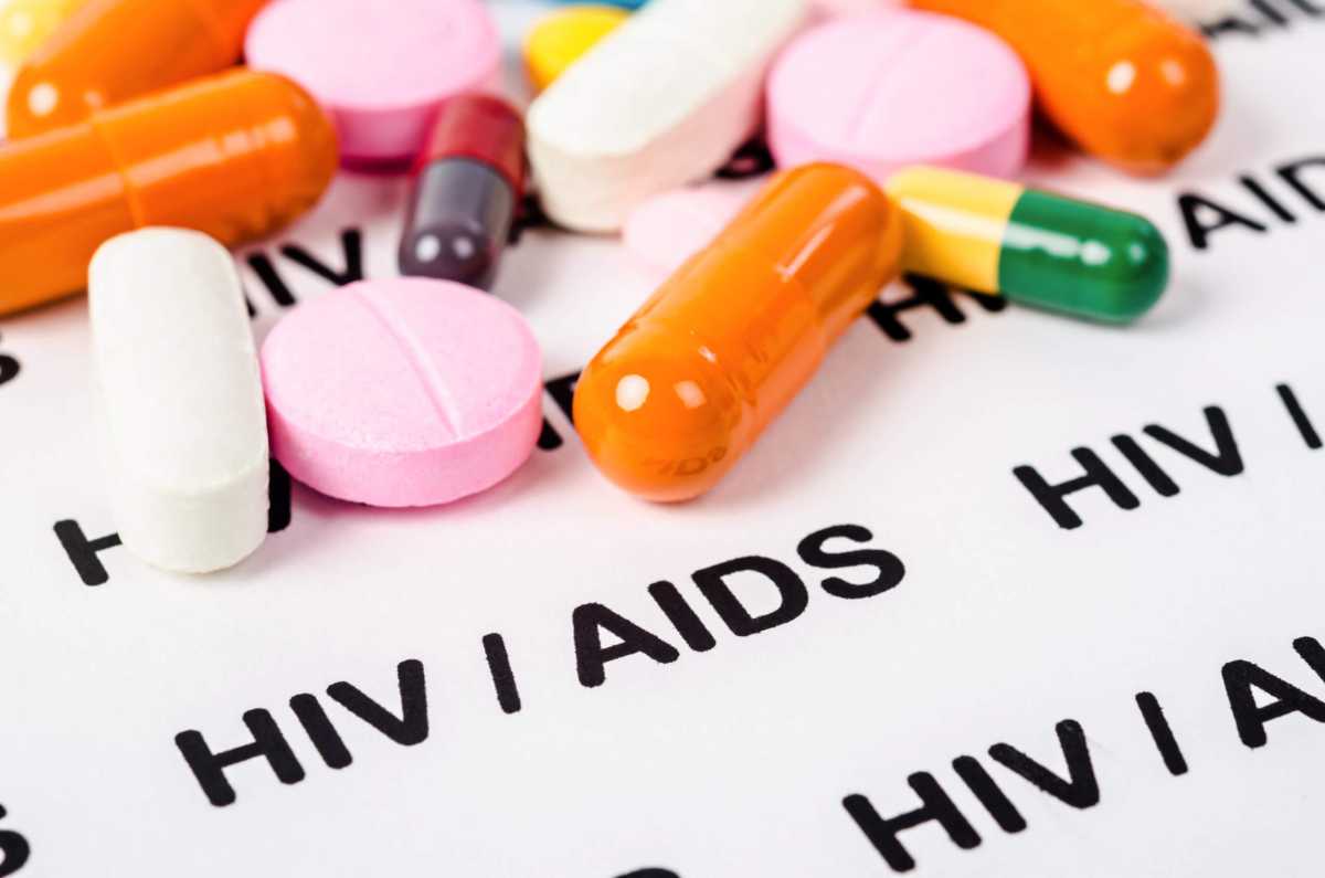 Pills on Hiv / aids paper background.