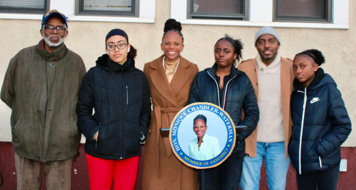 Assemblywoman Monique Chandler-Waterman is congratulated by her children, husband, Eric, and father at the opening of her 58th District office. 