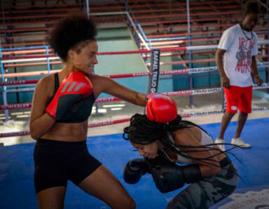 Boxer Giselle Bello Garcia, left, throws a punch at Ydamelys Moreno during a training session in Havana, Cuba, Monday, Dec. 5, 2022. Cuban officials announced on Monday that women boxers would be able to compete for the first time ever.