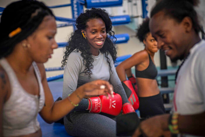 Boxer Legnis Cala, center, talks with fellow female boxers during a training session in Havana, Cuba, Monday, Dec. 5, 2022. Cuban officials announced on Monday that women boxers would be able to compete for the first time ever.