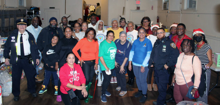 Alumni Association volunteers pose for a picture after serving scores of children toys in St. Paul's Lutheran Church annex in Brooklyn. 