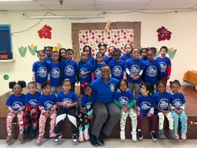 Beverley Campbell (center), executive director of the Afro American Parents Educational Center, Inc. in Jamaica, Queens, with children wearing blue T-shirts in commemoration of Diabetes Month.