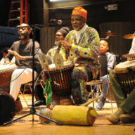 Kwanzaa musicians with Menes De Griot, center, performing at a past celebration.