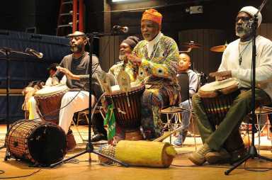 Kwanzaa musicians with Menes De Griot, center, performing at a past celebration.