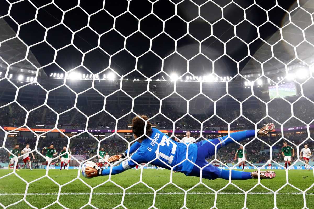 (EDITORS NOTE: In this photo taken from a remote camera from behind the goal) Robert Lewandowski of Poland shoots a penalty which is saved by Guillermo Ochoa of Mexico during the FIFA World Cup Qatar 2022 Group C match between Mexico and Poland at Stadium 974 on November 22, 2022 in Doha, Qatar.