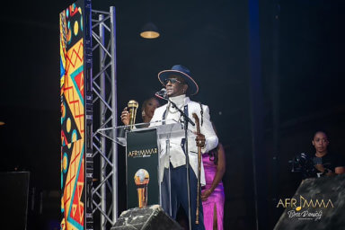 Grenadian Soca Artist Mr. Killa receives an award at the African Muzik Magazine Award ceremony in Texas.