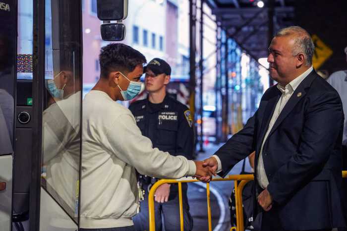 Mayor’s Office of Immigrant Affairs Commissioner Manuel Castro shakes hands as migrants step off the bus.