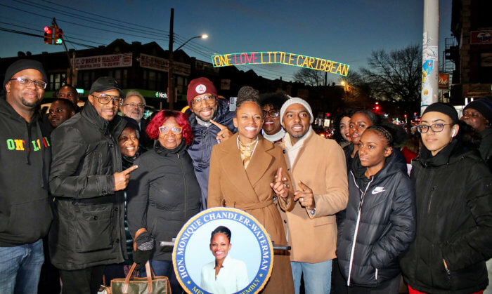 Nationals gathered to celebrate the beauty in their community at the unveiling of the One Love Little Caribbean holiday lights over the intersection of Utica and Church avenues in Brooklyn. District 43 Community Leader Akil Williams, Rev. Edward Richard Hinds, Assemblywoman Monique Chandler-Waterman, Mr. Waterman, and children, and many others, with the majestic lights in the backdrop.