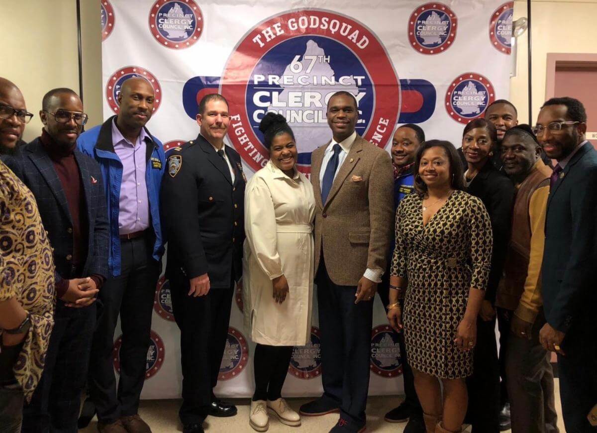 Pastor Gil Monrose (center) at Brookdale Hospital on Dec. 17 with members of the Godsquad