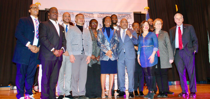 Colleagues join Assemblymember Monique Chandler Waterman on stage for a photo at her swearing in ceremony and gala, in Holy Family R.C. Church Annex, Canarsie. 