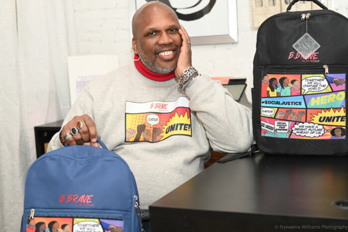 Wilbur Pack, Jr., fashion designer and creative director of the B.Brave by SK WiLBUR backpacks, with two of his backpacks. 