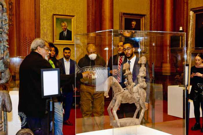 Eric Edwards, founder and executive director of the Cultural Museum of African Art, left, shows BP Antonio Reynoso around the exhibition.