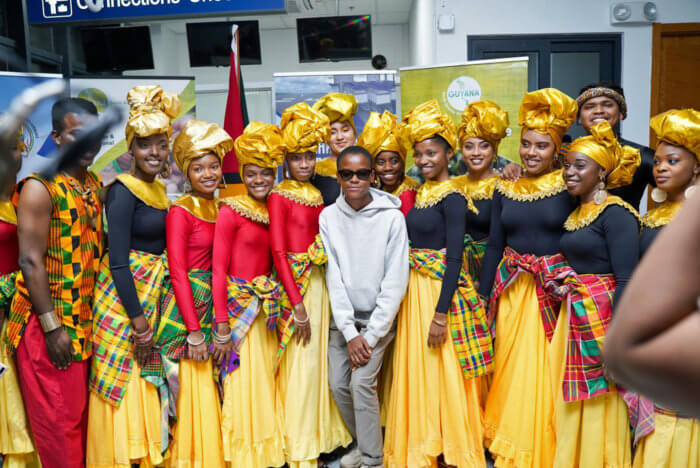 Black Panther star Letitia Wright strikes a pose with the National Dance Company which entertained her when she arrived with family members at Cheddi Jagan International Airport on Jan. 27.