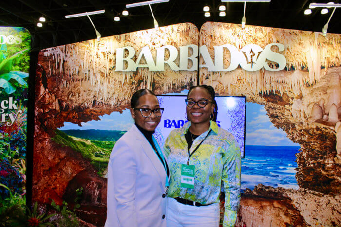 Elijah Cadogan, senior business development officer at Barbados Tourism Marketing Inc. New York, and Tenisha Holder, senior business development officer at Barbados Tourism Marketing Inc. New York, are pictured in the Barbados kiosk, at the recent New York Travel & Adventure Show at the Jacob Javits Center.