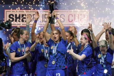 United States forward Alex Morgan, center, lifts the SheBelieves Cup with teammates after they won a soccer match against Brazil 2-0 Wednesday, Feb. 22, 2023, in Frisco, Texas.
