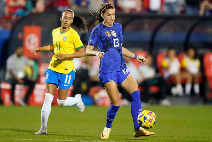 United States forward Alex Morgan (13) controls the ball in front of Brazil midfielder Adriana (11) during the first half of a SheBelieves Cup soccer match Wednesday, Feb. 22, 2023, in Frisco, Texas.
