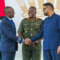 First Officer Haslyn Peters shakes the hand of President Irfaan Ali, as Chief of Staff of the Guyana Defense Force, Brigadier General Godfrey Bess, looks on.
