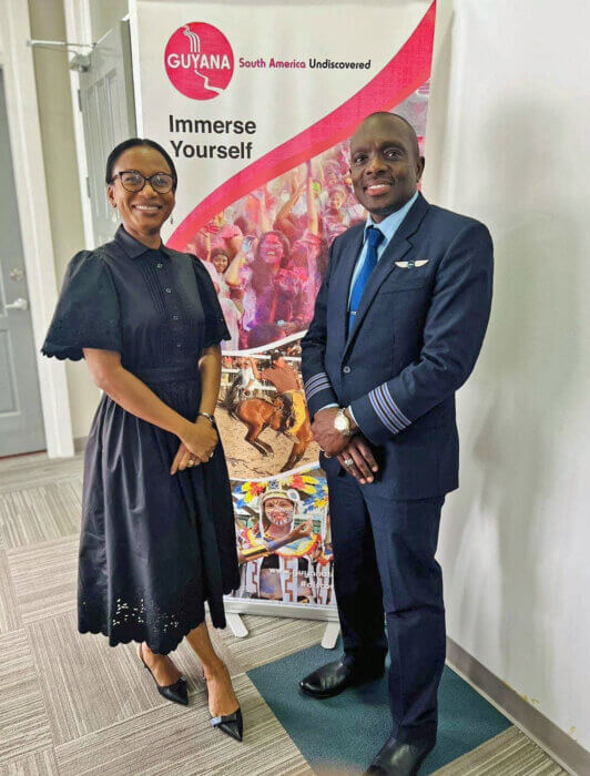 Minister of Tourism Industry and Commerce, Oneidge Walrond, greets First Officer Haslyn Peters at the Cheddi Jagan Int. Airport, Guyana on Feb. 23, after landing JetBlue flight #1965. 