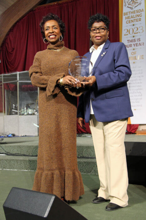 Congresswoman Yvette D. Clarke, left, receives award from CAGU member Dr. Jean Joseph.