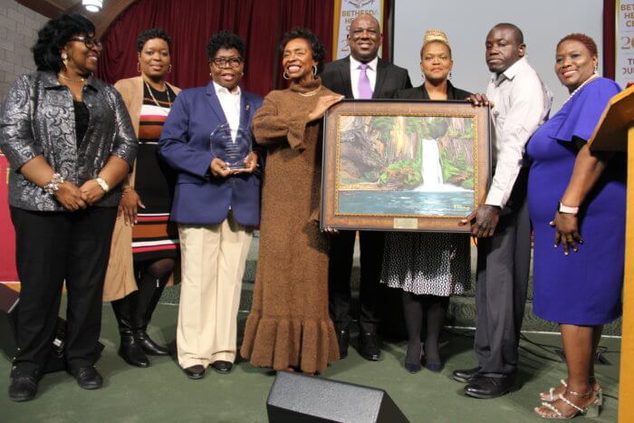 Congresswoman Clarke with portrait by Ghanaian autistic artist Amoako Buachie, flanked by CAGU members.